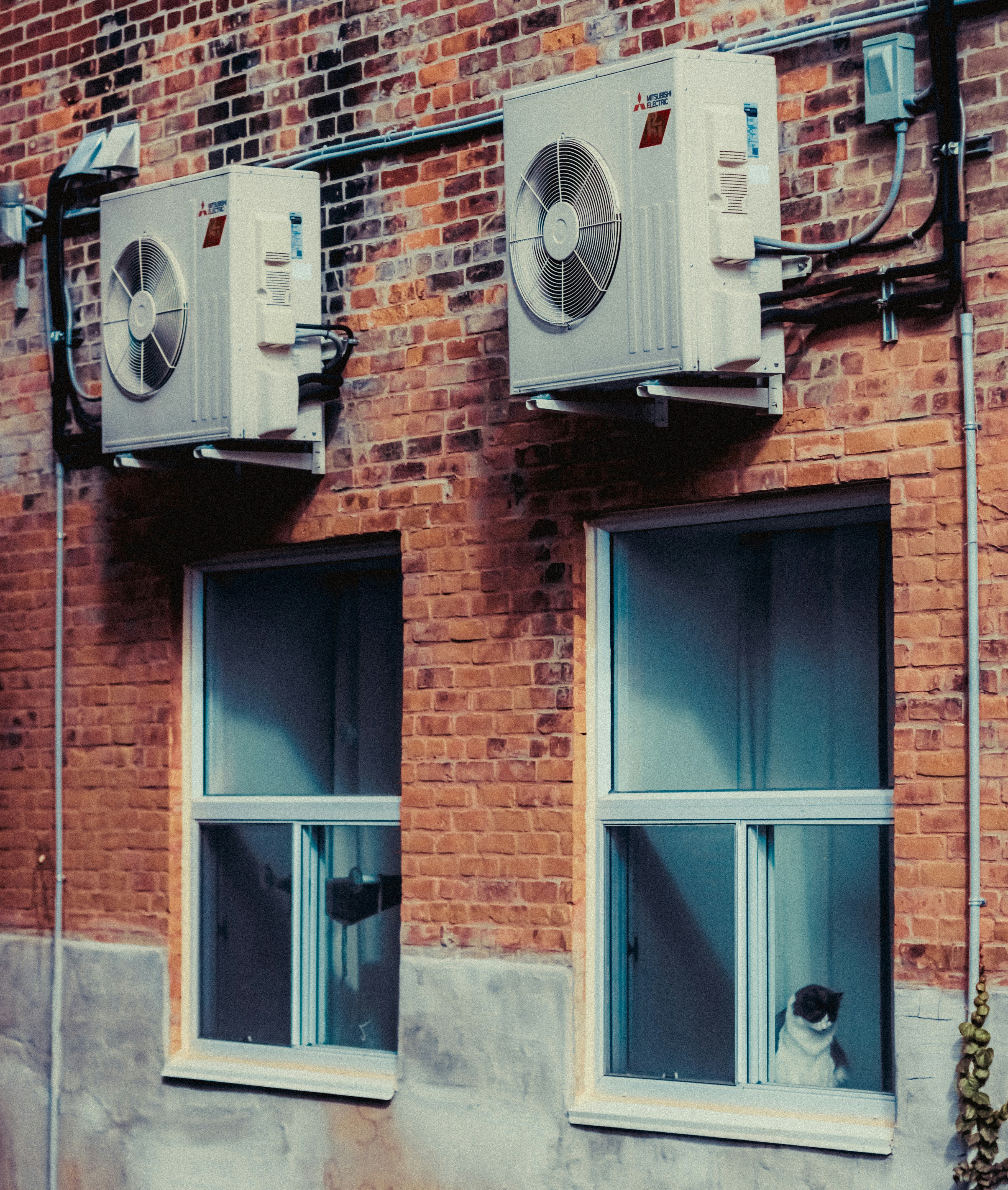 two heat pump units over two windows