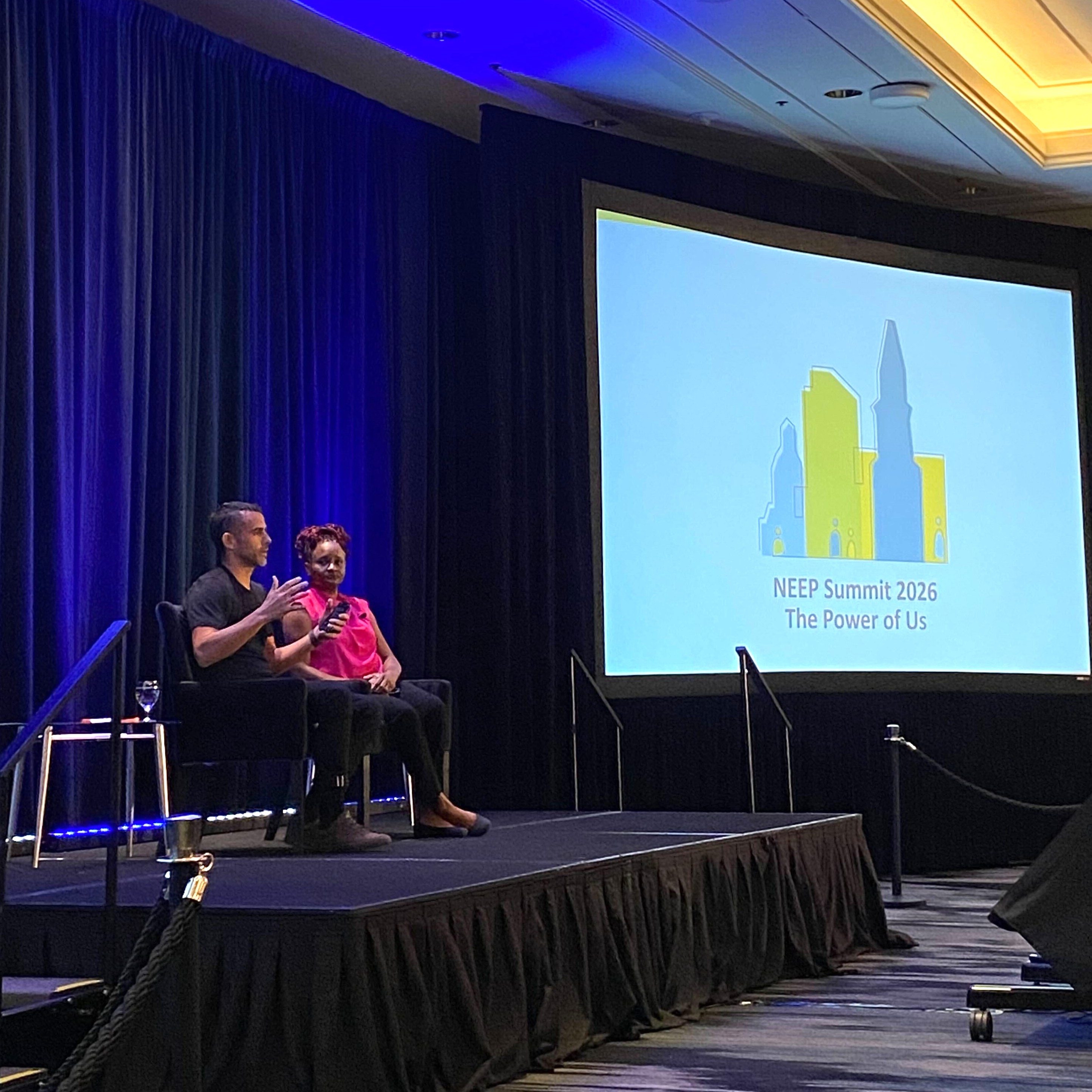 Two panelists sitting on stage