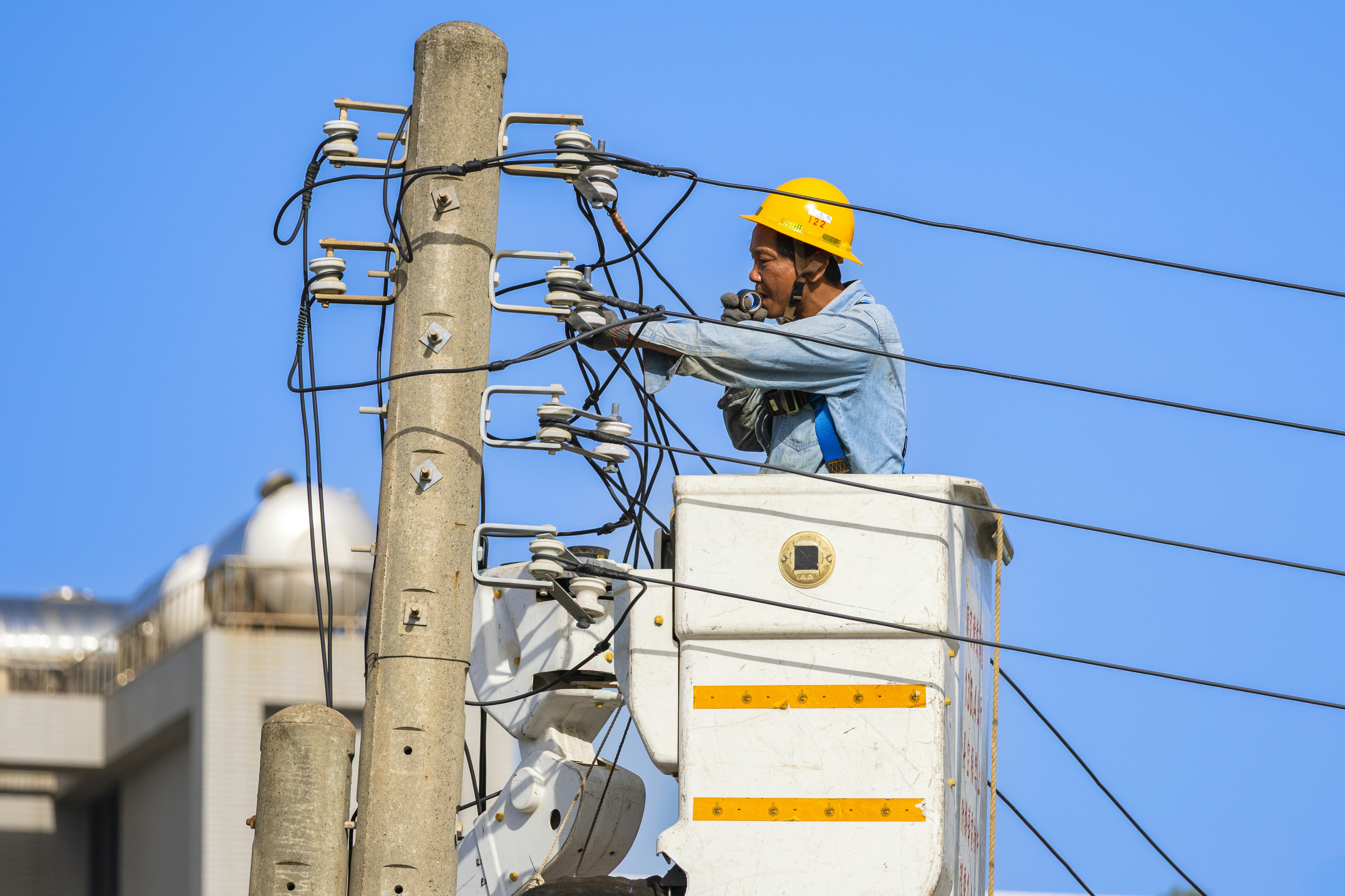Utility worker in cherry picker